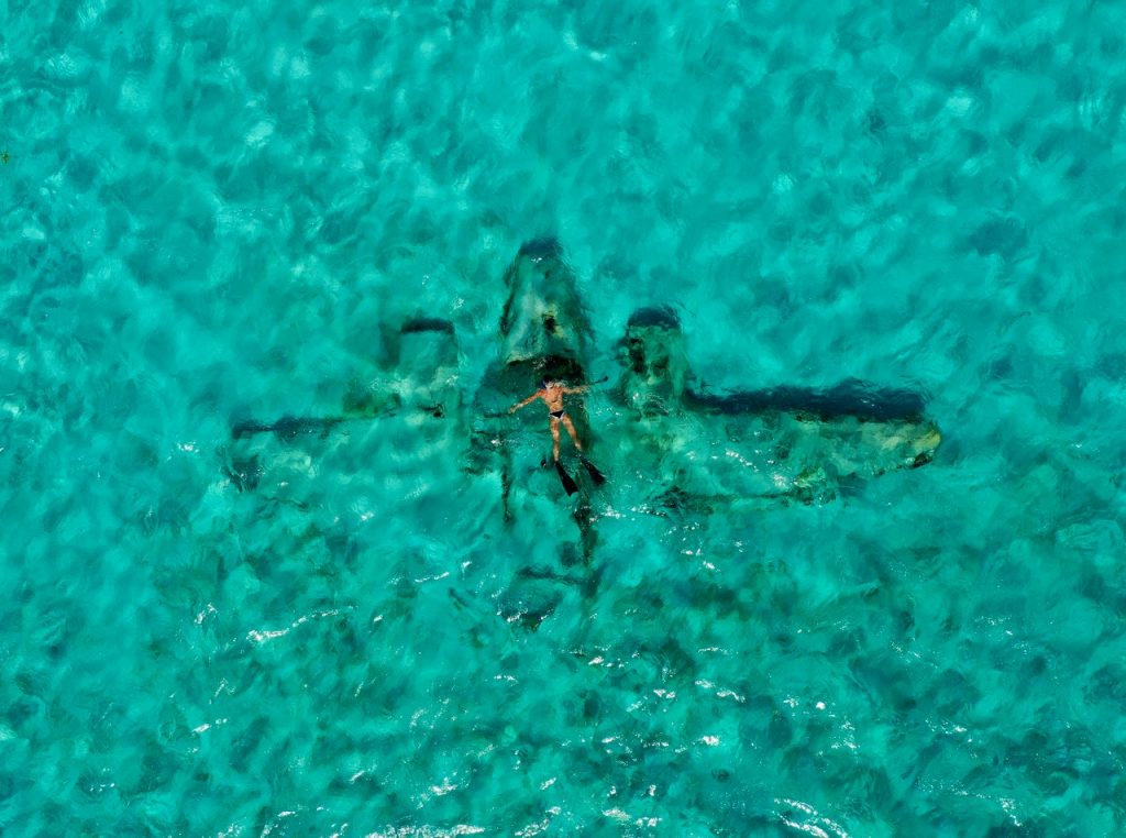 A man swimming in beautiful blue water.