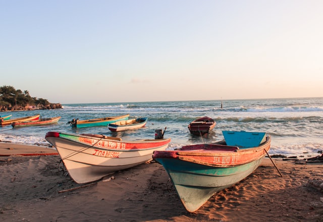 Boats on one of the must-see beaches in Jamaica.