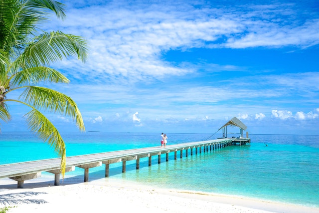 A couple walking on a dock in one of the best Caribbean islands, the Bahamas.