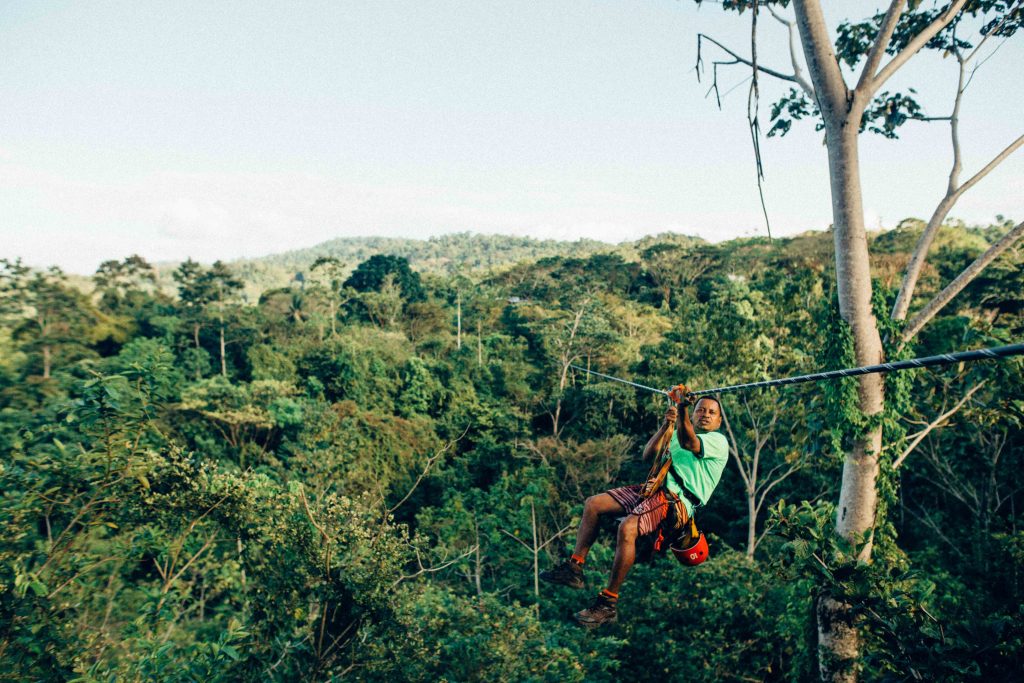  Man ziplining through the forest 