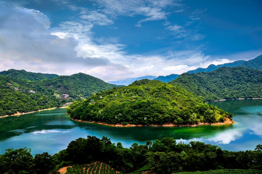 A beautiful high view of an island surrounded by a bright blue sea. 