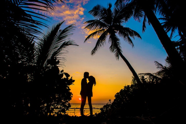 A couple kissing at night in the Caribbean