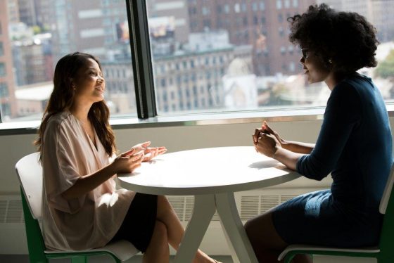 A woman talking with her translator colleague 