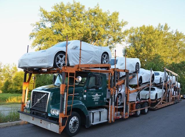 A truck with cars on the back of it