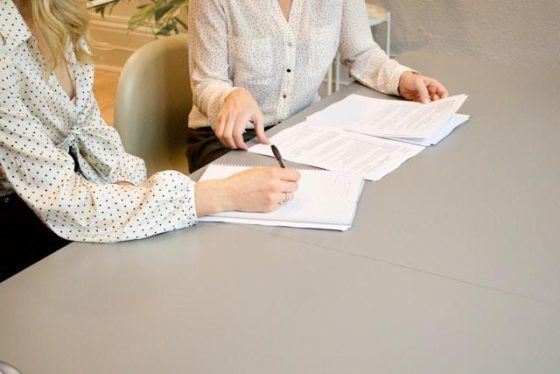 A woman signing a document 